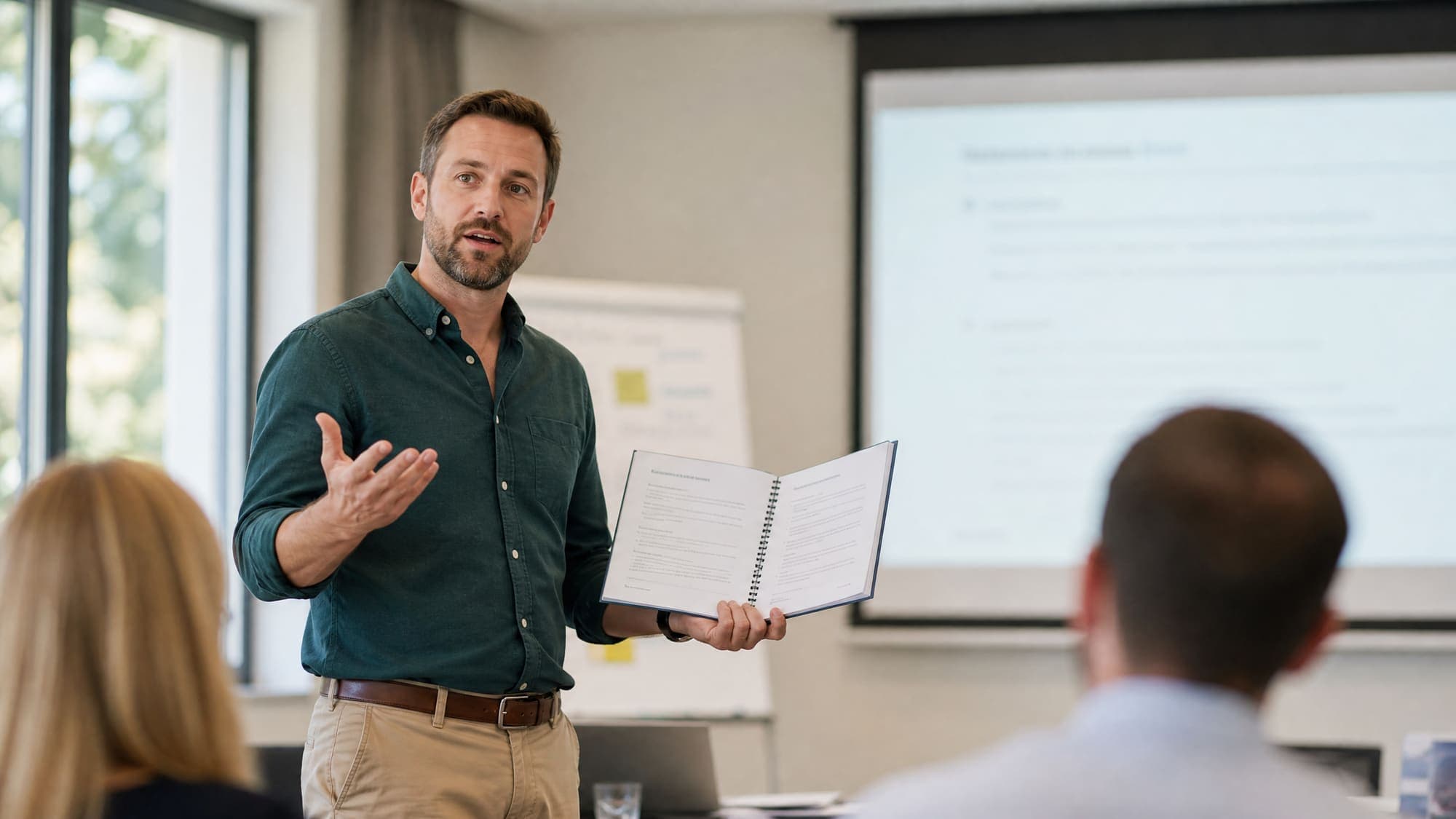 A facilitator holding an open printed guide